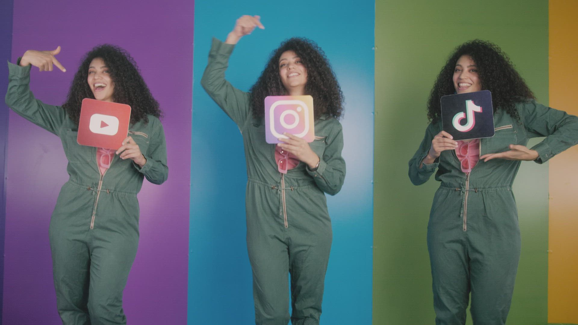 A presenter holding social app icons on a colourful set